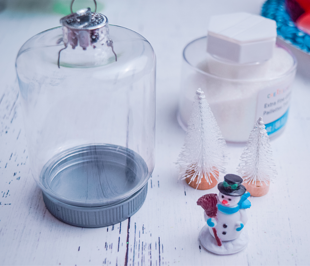 Materials to make the Dollar Tree Snowman Mason Jar Ornament