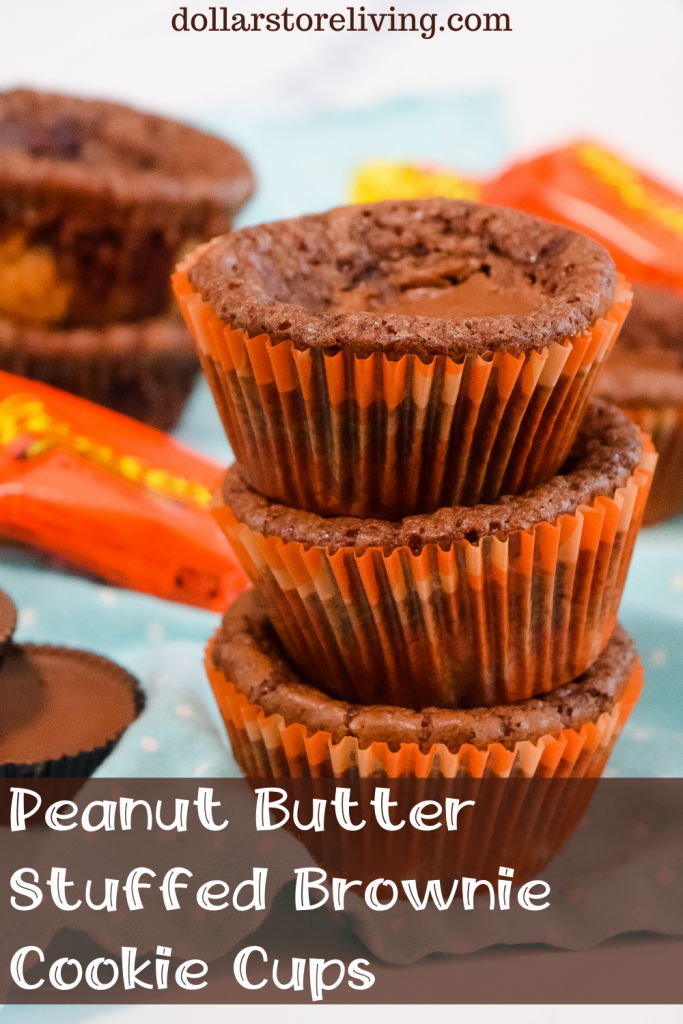 Title image with 3 peanut butter stuffed brownie cookie cups stacked on top of each other in orange cupcake liners on a blue polka dot towel.