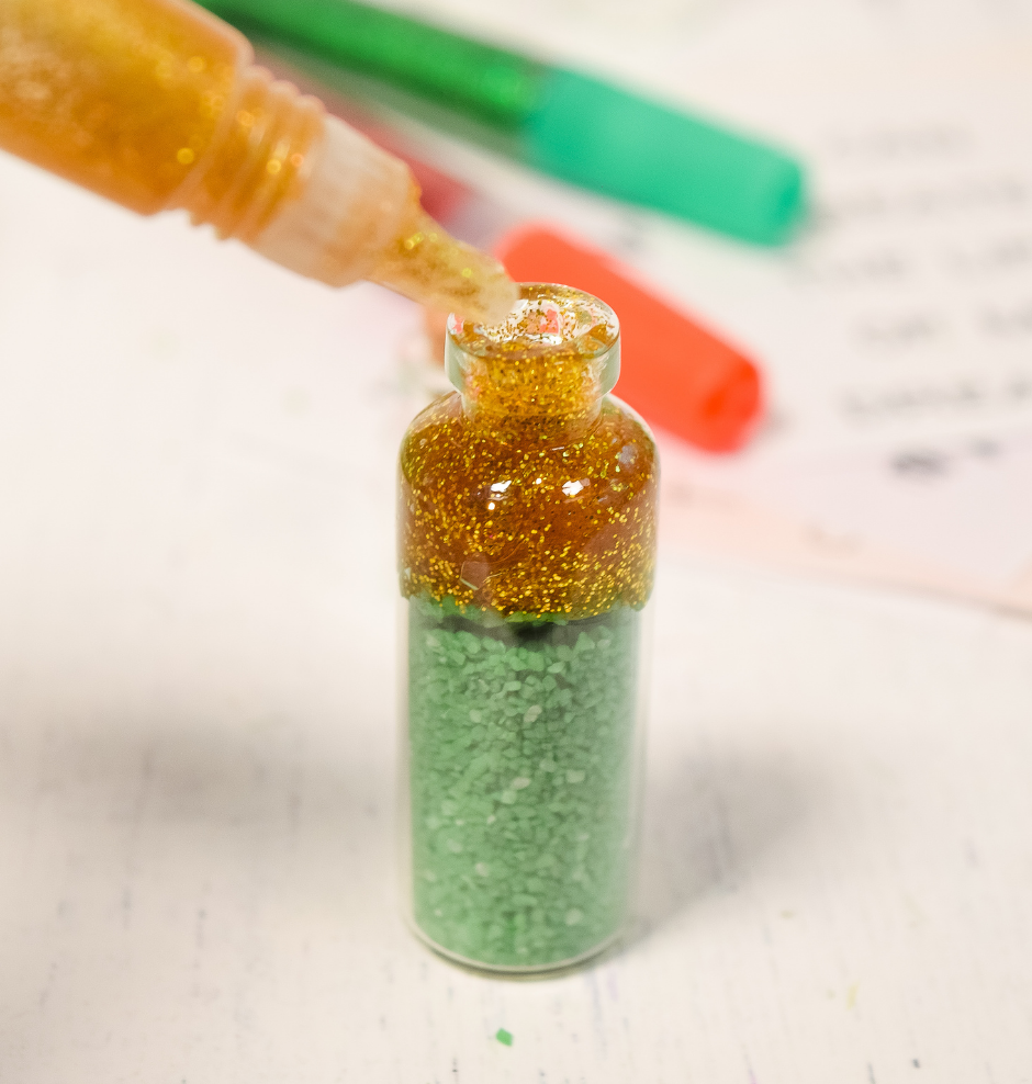 Finish off the top of the mini spell jar with glitter glue. 